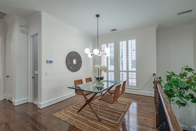 dining space with crown molding, dark wood-type flooring, and a chandelier