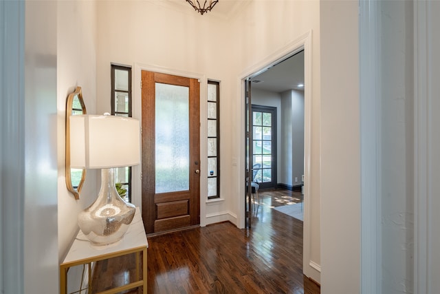 foyer featuring dark hardwood / wood-style floors and crown molding