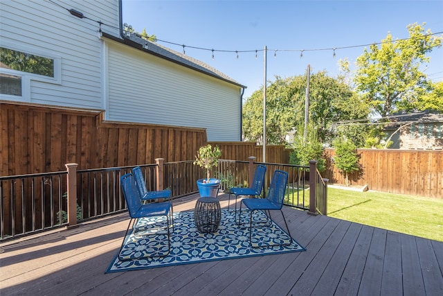 wooden deck featuring a lawn