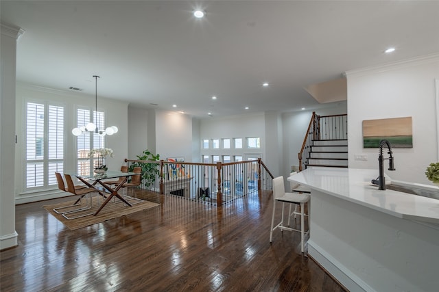 interior space featuring a notable chandelier, crown molding, and dark hardwood / wood-style floors