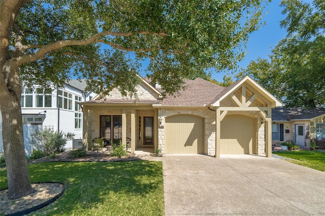 view of front of home with a front yard and a garage