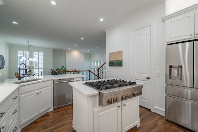 kitchen featuring sink, a kitchen island, white cabinetry, stainless steel appliances, and dark hardwood / wood-style floors