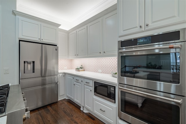 kitchen featuring crown molding, white cabinetry, stainless steel appliances, and dark hardwood / wood-style flooring