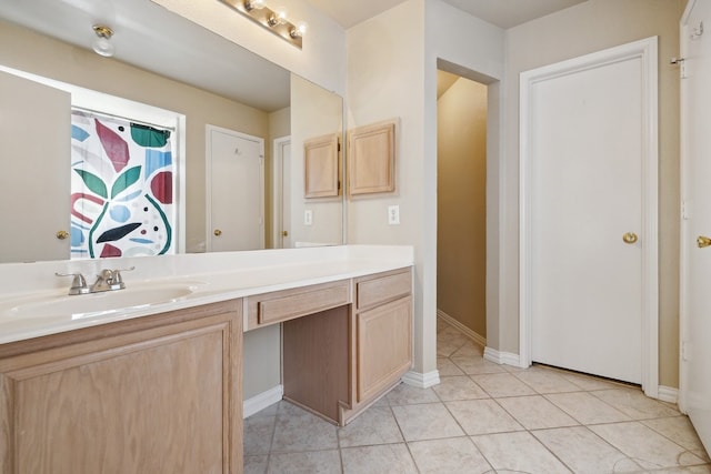 bathroom with tile patterned flooring and vanity