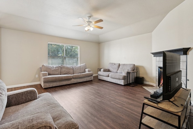 living room featuring dark hardwood / wood-style flooring, a textured ceiling, and ceiling fan