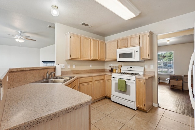 kitchen with ceiling fan, light brown cabinets, white appliances, sink, and light tile patterned floors