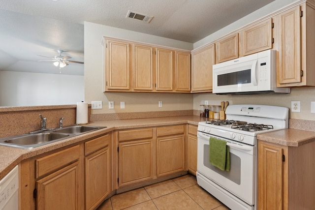 kitchen with ceiling fan, light tile patterned flooring, sink, white appliances, and a textured ceiling