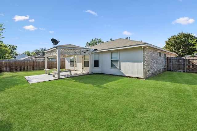 rear view of house featuring a yard and a patio area