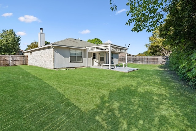 back of house with a lawn and a patio area