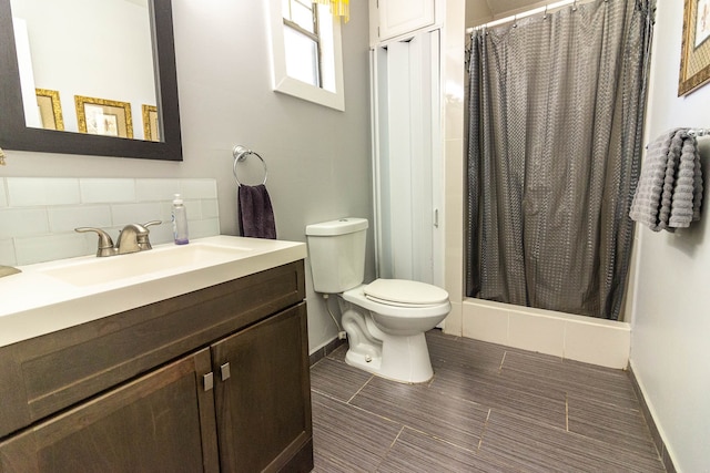 bathroom featuring vanity, walk in shower, toilet, and tasteful backsplash