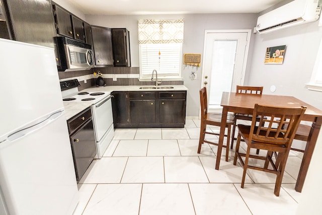 kitchen featuring a wall unit AC, tasteful backsplash, white appliances, sink, and light tile patterned flooring