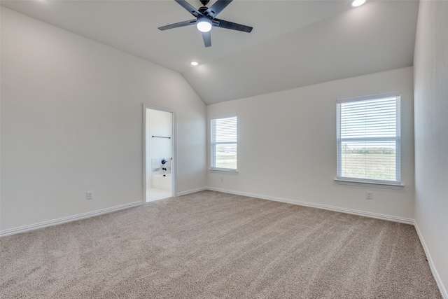 unfurnished room featuring light colored carpet, a healthy amount of sunlight, and lofted ceiling