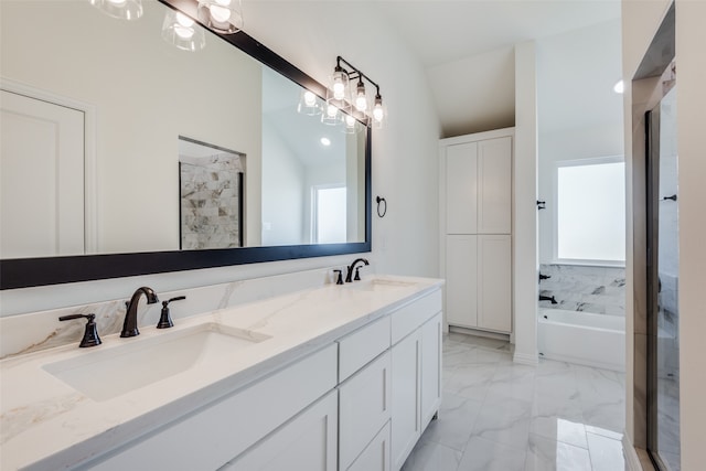 bathroom with vanity, independent shower and bath, and vaulted ceiling