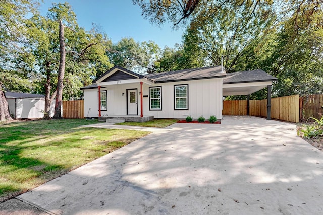 single story home with a front lawn and a carport