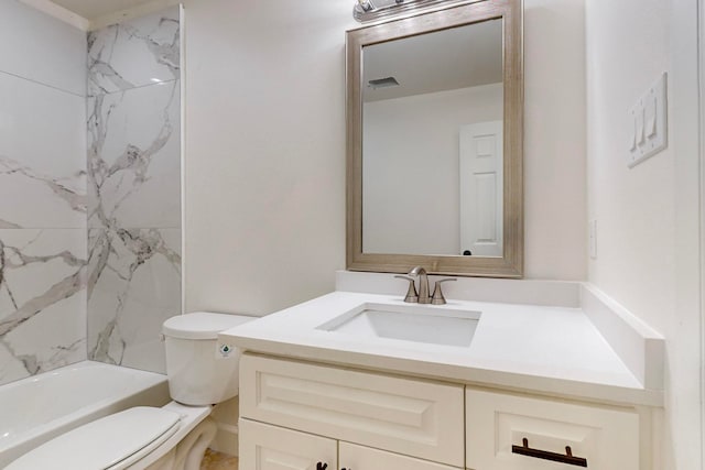 full bathroom with tiled shower / bath, vanity, and toilet