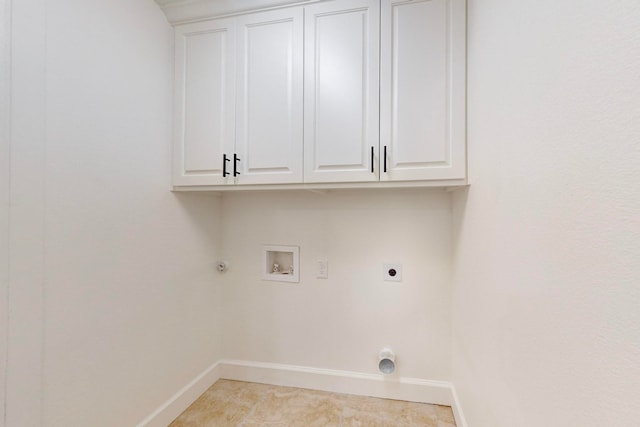 washroom with cabinets, hookup for a gas dryer, hookup for an electric dryer, hookup for a washing machine, and light tile patterned floors