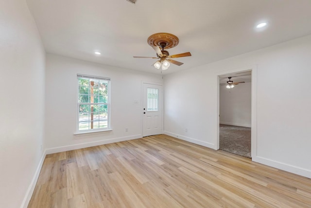 spare room featuring light hardwood / wood-style floors and ceiling fan