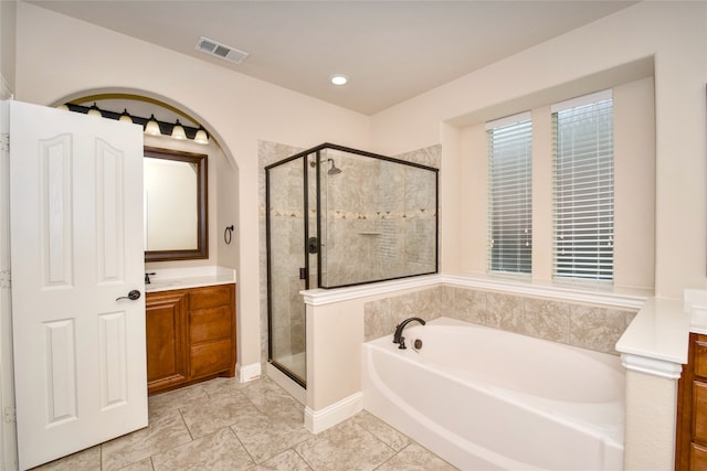 bathroom featuring vanity and plus walk in shower