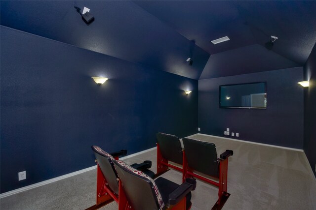 cinema room with lofted ceiling and carpet flooring