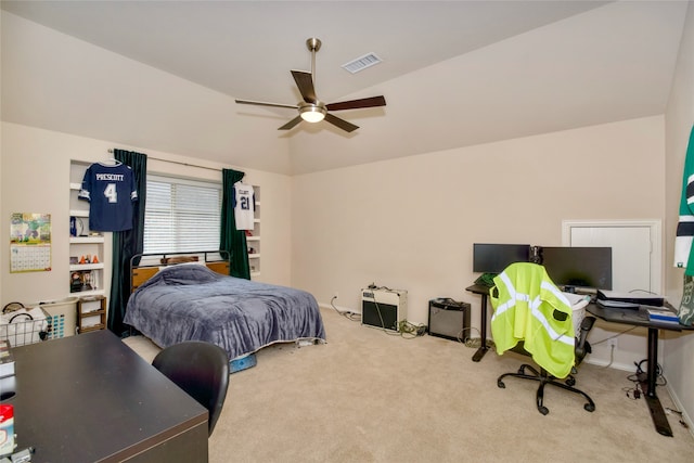 carpeted bedroom with vaulted ceiling and ceiling fan