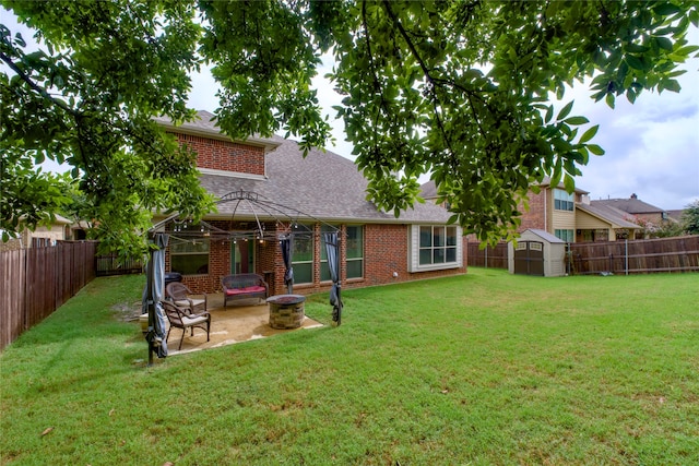 rear view of house featuring a storage shed, a patio, and a yard