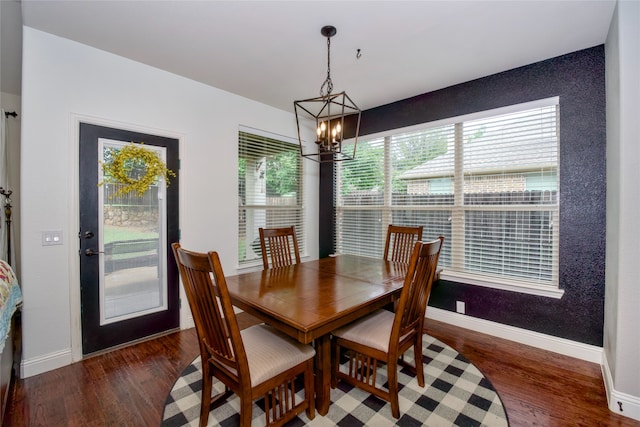 dining space featuring a chandelier, dark hardwood / wood-style flooring, and a healthy amount of sunlight