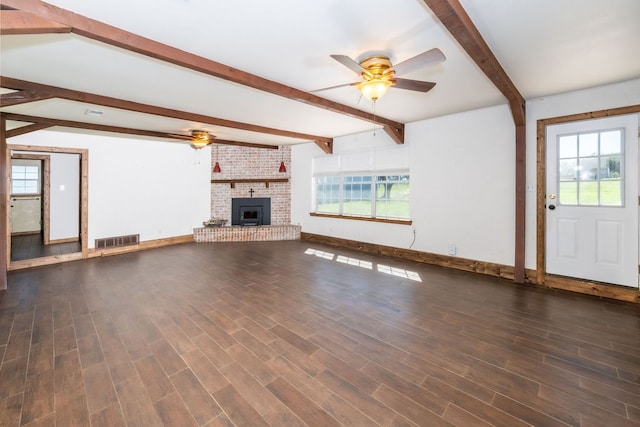 unfurnished living room with dark hardwood / wood-style flooring, a wealth of natural light, and ceiling fan