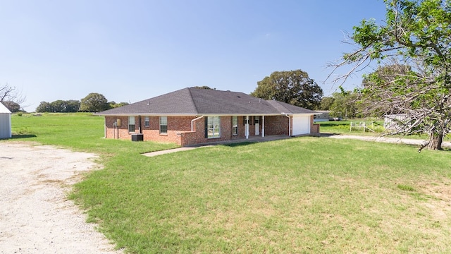 view of front of property featuring a garage and a front yard