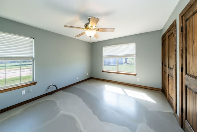 unfurnished bedroom featuring ceiling fan and multiple windows