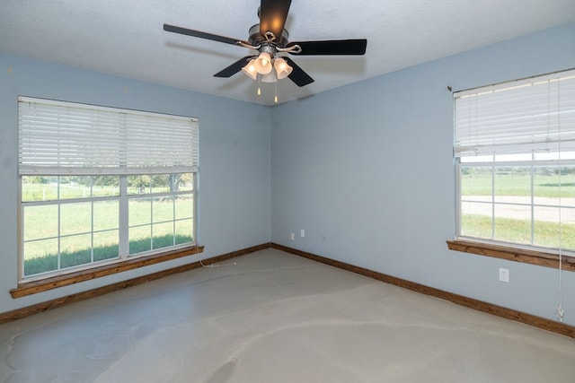 unfurnished room featuring ceiling fan and a textured ceiling