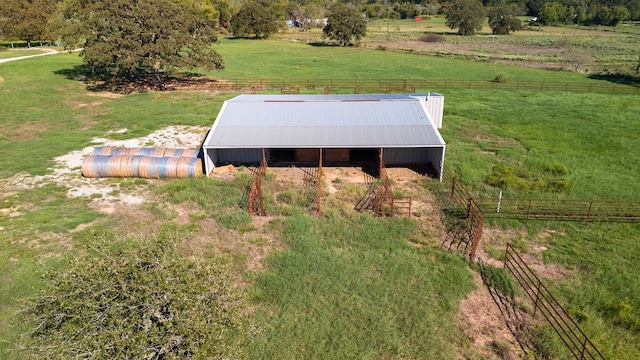 view of storm shelter featuring a rural view and an outbuilding