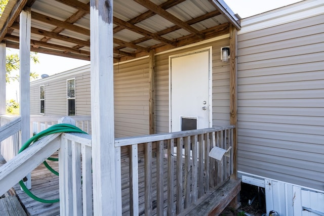 property entrance featuring a wooden deck