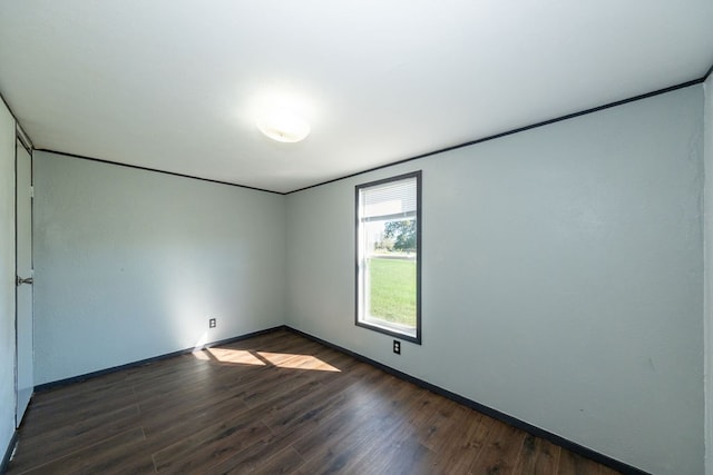 unfurnished room with dark hardwood / wood-style floors