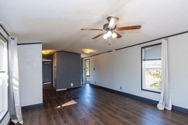 empty room with dark wood-type flooring and ceiling fan