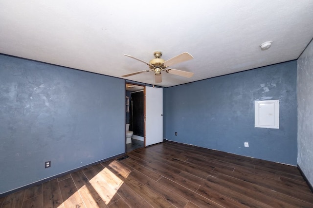 unfurnished room with electric panel, dark hardwood / wood-style flooring, and ceiling fan