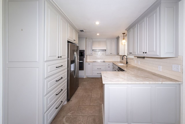 kitchen with white cabinets, stainless steel appliances, hanging light fixtures, and sink