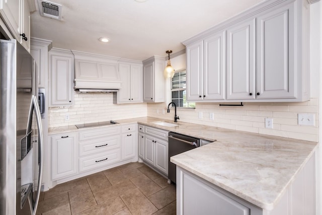 kitchen with light stone countertops, white cabinets, sink, hanging light fixtures, and appliances with stainless steel finishes