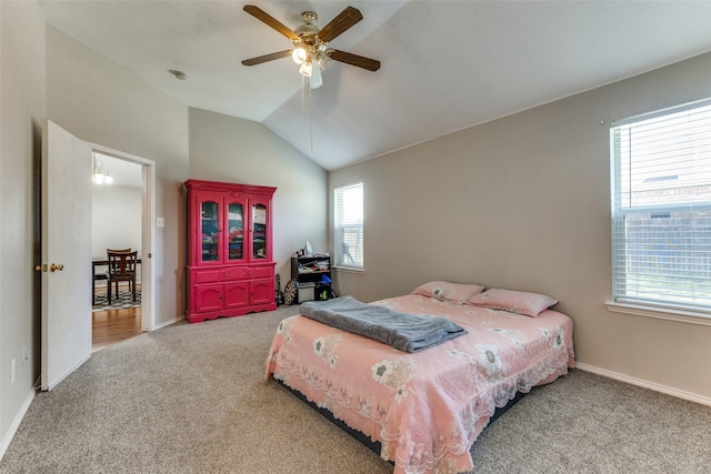 carpeted bedroom with vaulted ceiling and ceiling fan