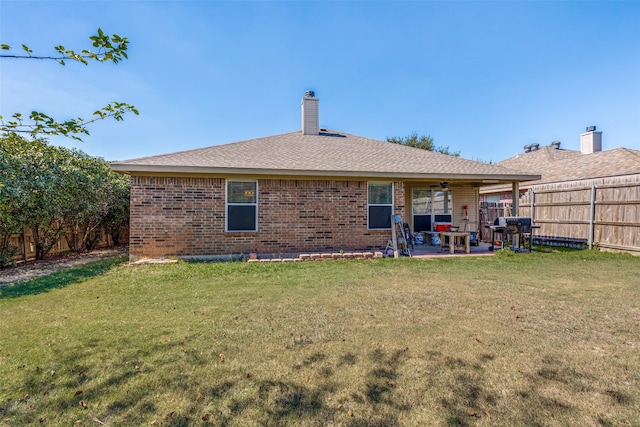 back of house with a yard and a patio area