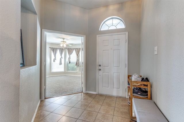 tiled entrance foyer with ceiling fan