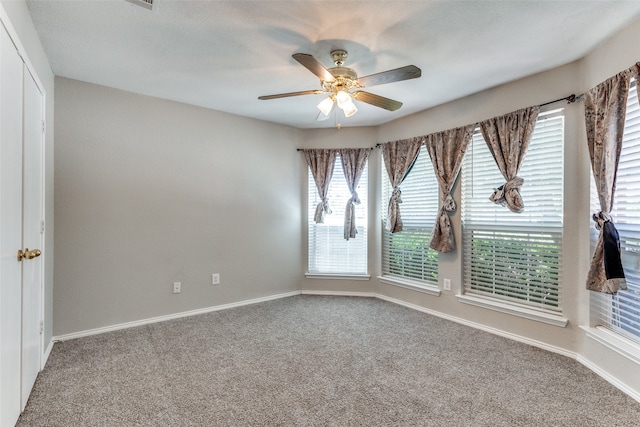 empty room with carpet flooring and ceiling fan