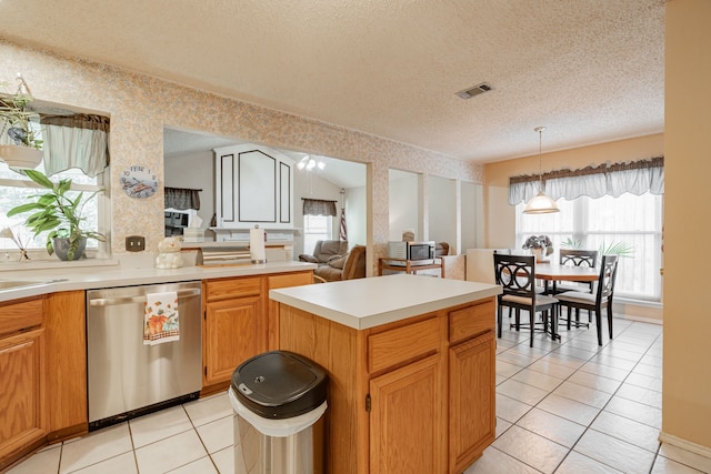 kitchen featuring stainless steel appliances, light tile patterned flooring, lofted ceiling, and a textured ceiling