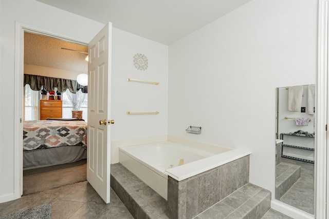 bathroom featuring tile patterned flooring, a bathtub, and a textured ceiling