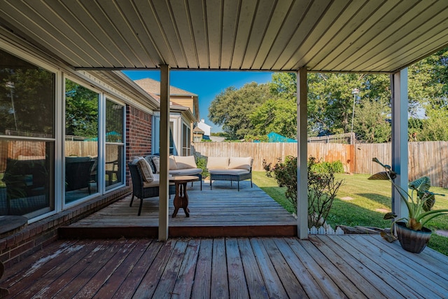 wooden terrace featuring an outdoor hangout area and a yard