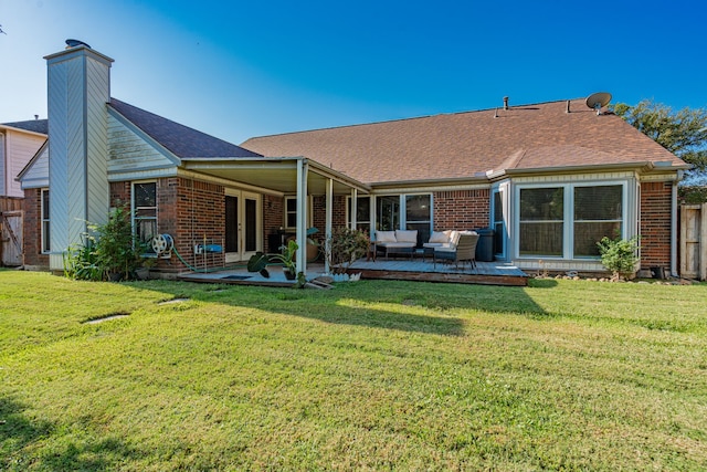 back of property featuring outdoor lounge area, a deck, and a lawn