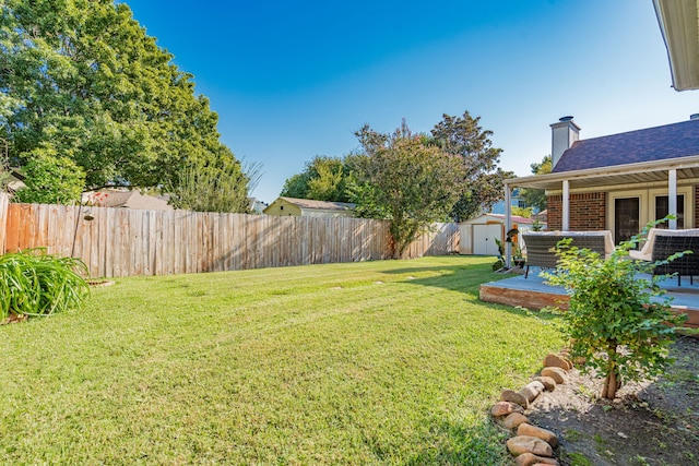 view of yard with a storage unit and a patio area