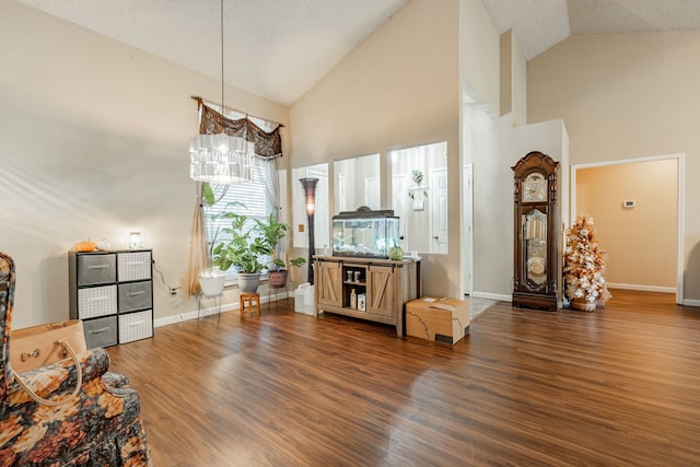 living room with a notable chandelier, dark hardwood / wood-style flooring, and a textured ceiling