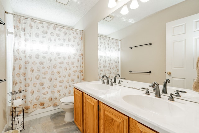 full bathroom featuring vanity, shower / tub combo, toilet, and a textured ceiling