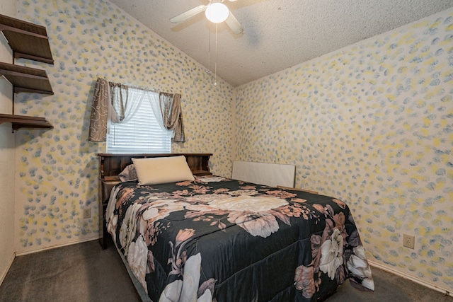 bedroom with dark carpet, vaulted ceiling, a textured ceiling, and ceiling fan