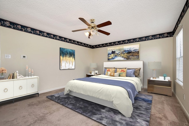 carpeted bedroom with a textured ceiling, ceiling fan, and multiple windows